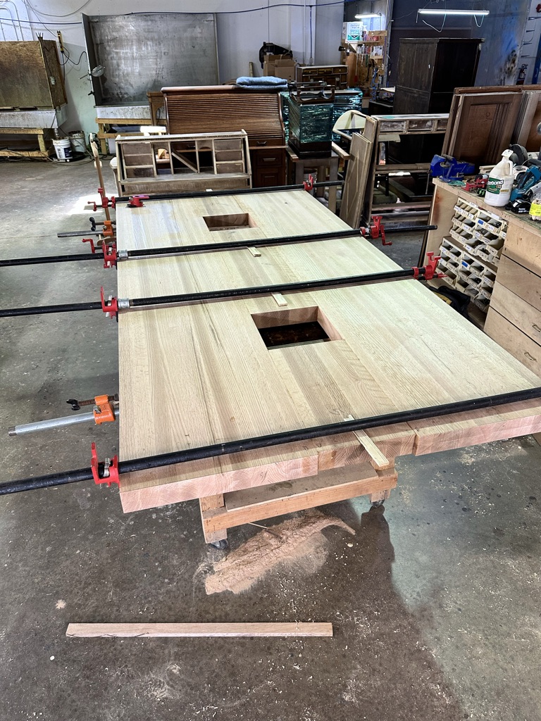 Beautiful, high quality custom fondu table top in the process of being glued together and held in tack with clamps